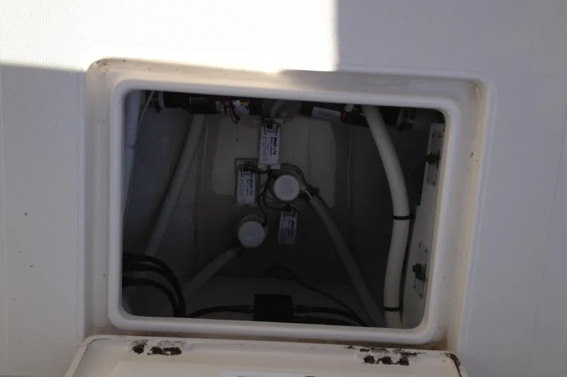Lady Michelle Yacht Photos Pics Access hatch of a 2012 Jupiter 29 FS CC boat, showing internal wiring and components.