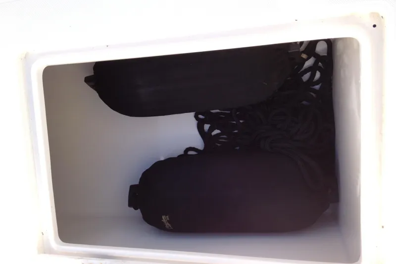 Lady Michelle Yacht Photos Pics Storage compartment with black fenders and ropes on a 2012 Jupiter 29 FS CC boat.