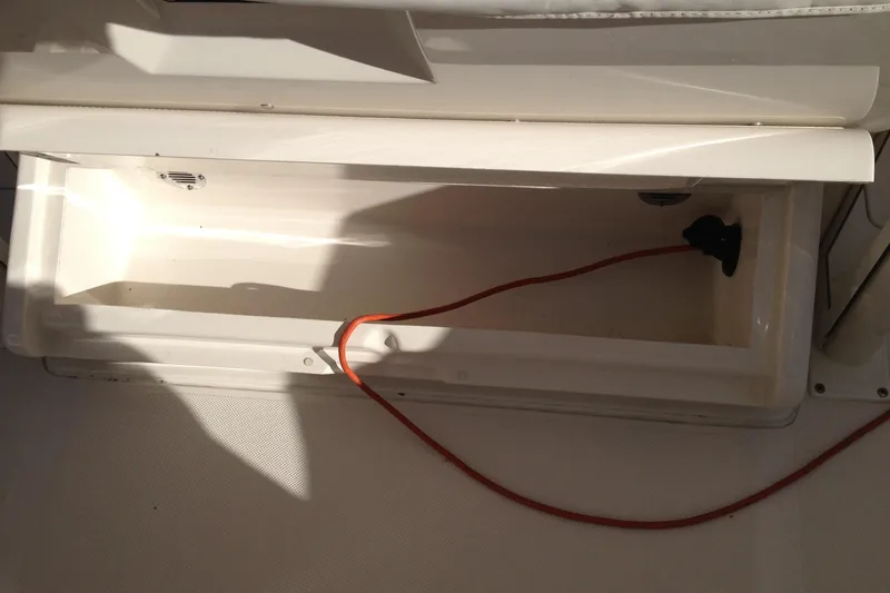 Lady Michelle Yacht Photos Pics Open storage compartment in 2012 Jupiter 29 FS CC boat with red cable inside.