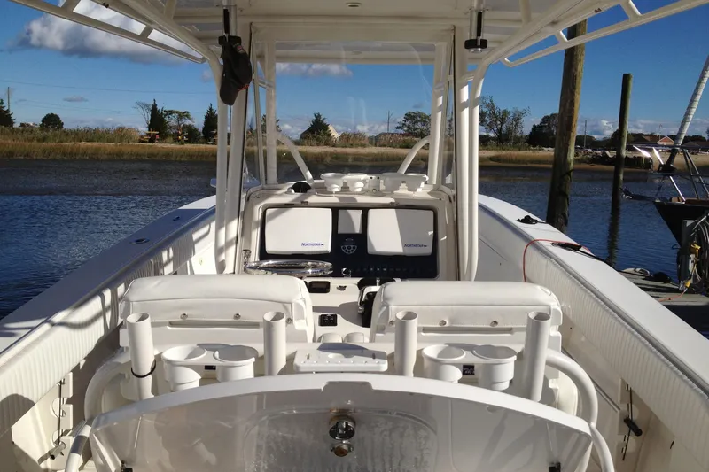 Lady Michelle Yacht Photos Pics 2012 Jupiter 29 FS CC boat interior with fishing rod holders and navigation equipment.