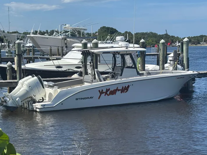  Yacht Photos Pics 2023 Stingray 273 CC boat docked at marina, featuring dual outboard engines.