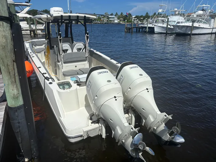  Yacht Photos Pics 2023 Stingray 273 CC boat with twin 300 horsepower engines docked at marina.