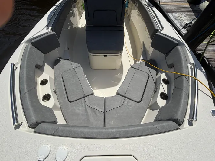  Yacht Photos Pics 2023 Stingray 273 CC boat interior with gray cushioned seating and cup holders.