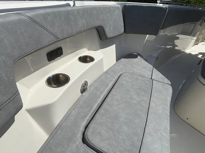  Yacht Photos Pics 2023 Stingray 273 CC boat interior with gray seating and cup holders.