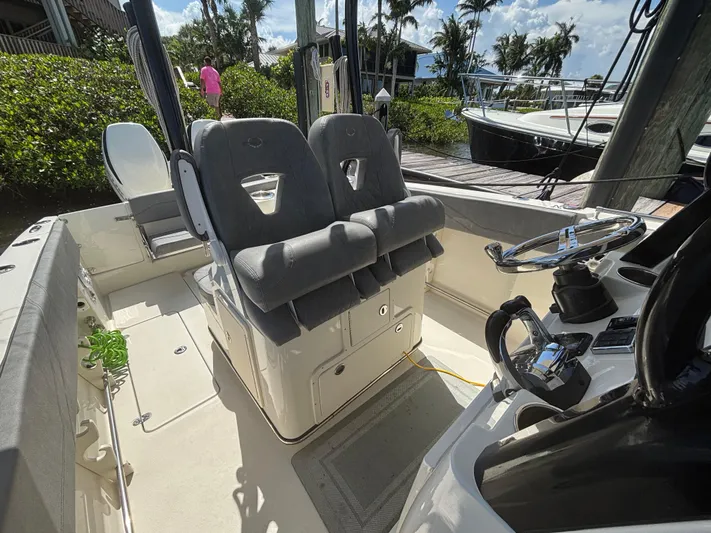  Yacht Photos Pics 2023 Stingray 273 CC boat interior with dual seats and steering console.