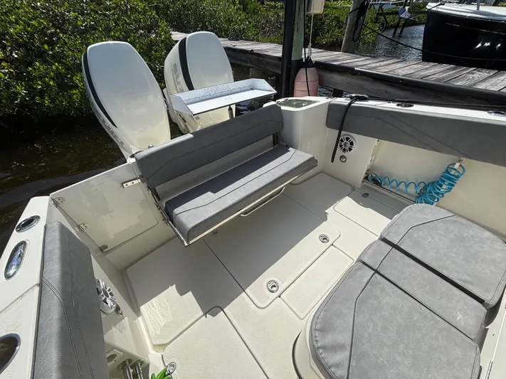  Yacht Photos Pics 2023 Stingray 273 CC boat interior with seating and dual outboard motors.
