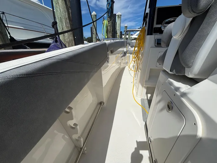  Yacht Photos Pics 2023 Stingray 273 CC boat interior with seating and storage compartments.