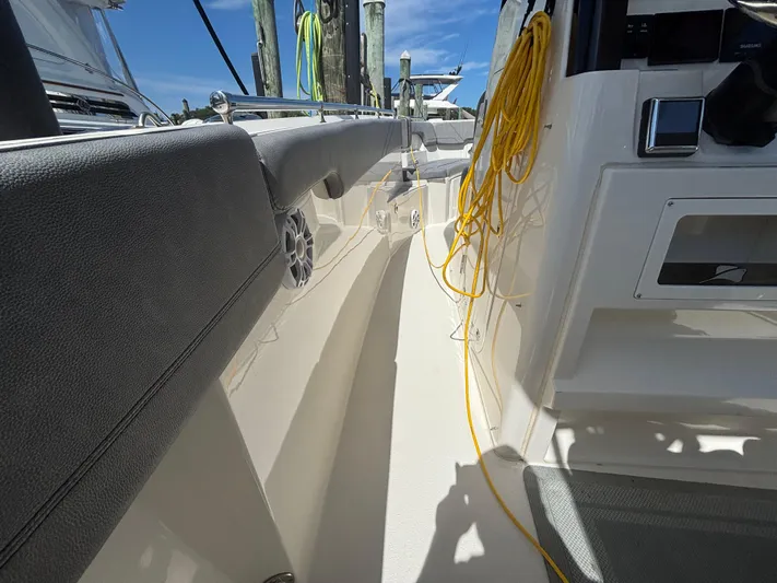  Yacht Photos Pics 2023 Stingray 273 CC boat interior with seating, speaker, and yellow rope.