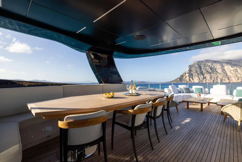  Yacht Photos Pics Luxurious 2024 Filippetti F100 yacht deck with elegant seating and ocean view.