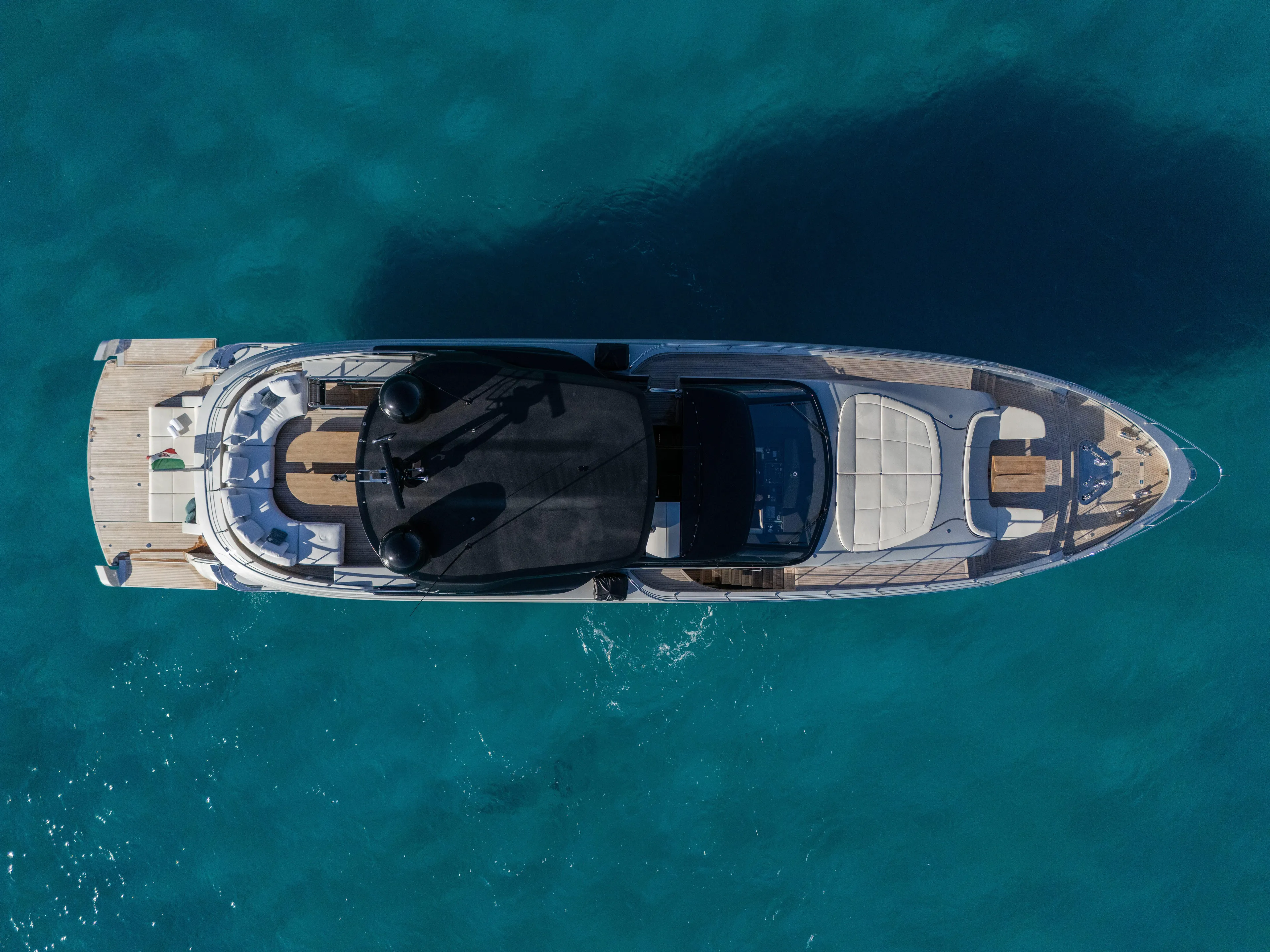  Yacht Photos Pics Aerial view of 2024 Filippetti F100 yacht on clear blue water.