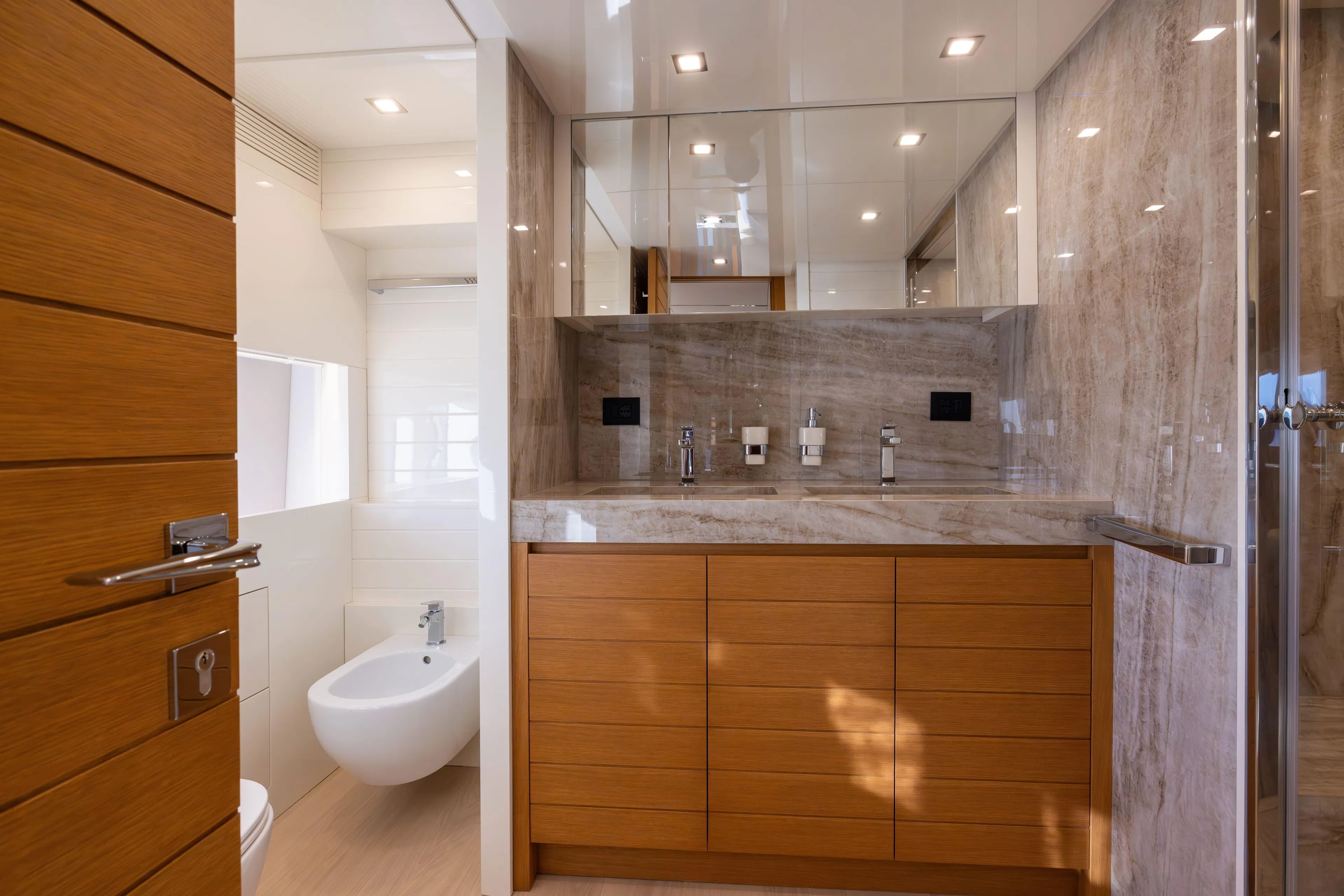  Yacht Photos Pics Luxurious bathroom in 2024 Filippetti F100 yacht with modern fixtures and wooden cabinetry.