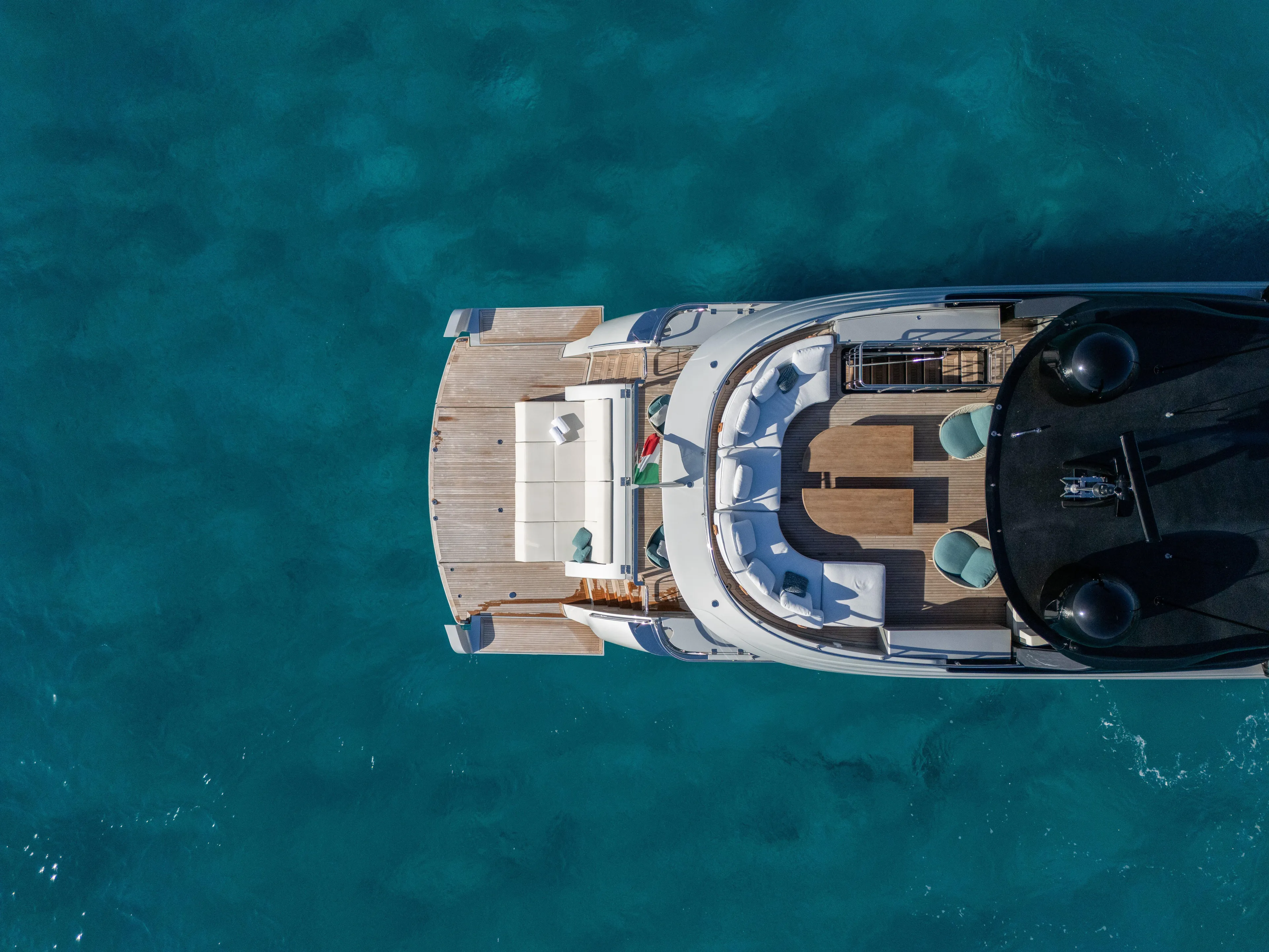  Yacht Photos Pics Aerial view of 2024 Filippetti F100 yacht on clear blue water.