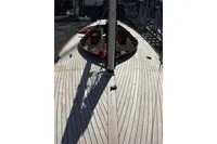 2007 Latitude 46 Tofinou 7 sailboat deck with wooden finish and mast.