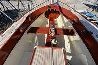 2007 Latitude 46 Tofinou 7 sailboat interior with polished wood and nautical ropes.