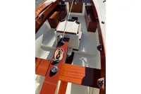 Interior view of 2007 Latitude 46 Tofinou 7 sailboat, featuring wooden deck and seating.