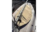 2007 Latitude 46 Tofinou 7 sailboat deck with beige cover and mast.