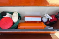 Storage compartment on a 2007 Latitude 46 Tofinou 7 with safety and maintenance items.