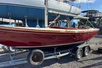 2007 Latitude 46 Tofinou 7 sailboat on trailer, displayed in a boatyard.