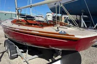2007 Latitude 46 Tofinou 7 sailboat on trailer, displayed in a marina setting.