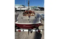 2007 Latitude 46 Tofinou 7 sailboat on trailer, docked in a marina.