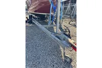 2007 Latitude 46 Tofinou 7 sailboat on a trailer, parked on gravel.