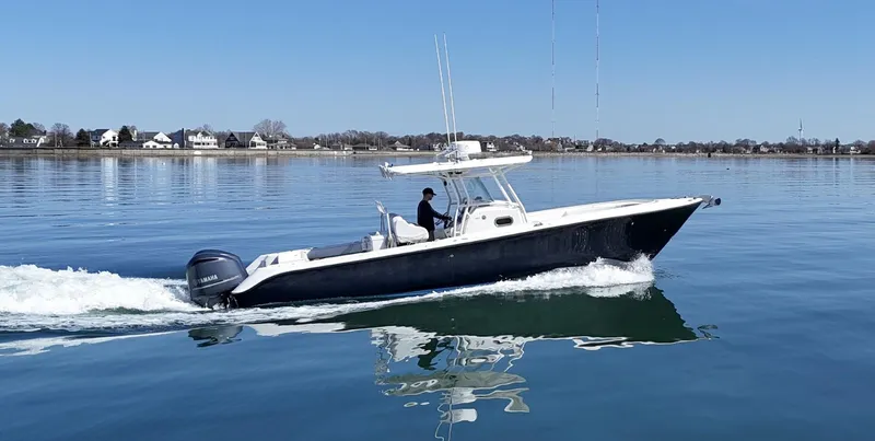  Yacht Photos Pics 2009 Edgewater 318CC boat cruising on calm water with clear blue sky.