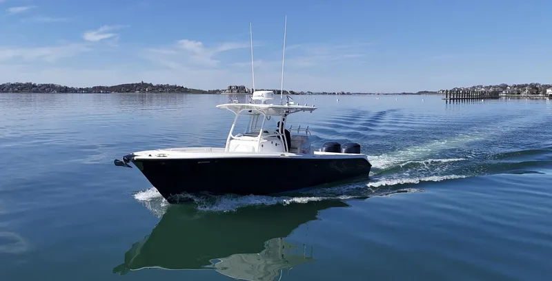  Yacht Photos Pics 2009 Edgewater 318CC boat cruising on calm water under a clear blue sky.