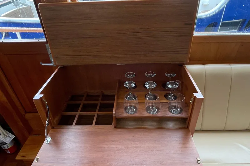 Mercator Yacht Photos Pics Wooden bar cabinet with wine glass storage on a 1985 Grand Banks 42 Classic yacht.