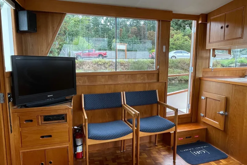 Mercator Yacht Photos Pics Interior of 1985 Grand Banks 42 Classic yacht with wooden furnishings and seating area.