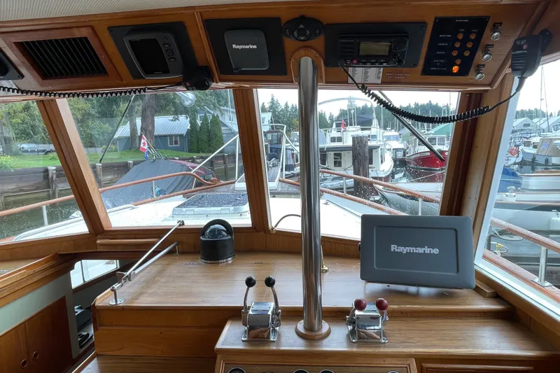 Mercator Yacht Photos Pics 1985 Grand Banks 42 Classic helm with Raymarine navigation, docked at marina.