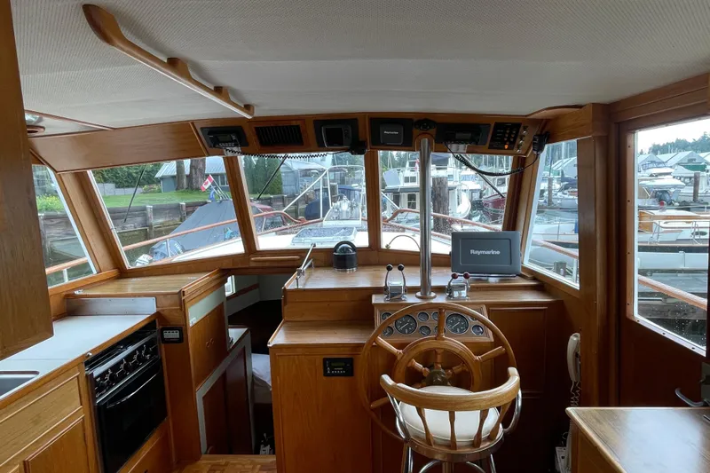 Mercator Yacht Photos Pics 1985 Grand Banks 42 Classic yacht interior with wooden helm and navigation equipment.