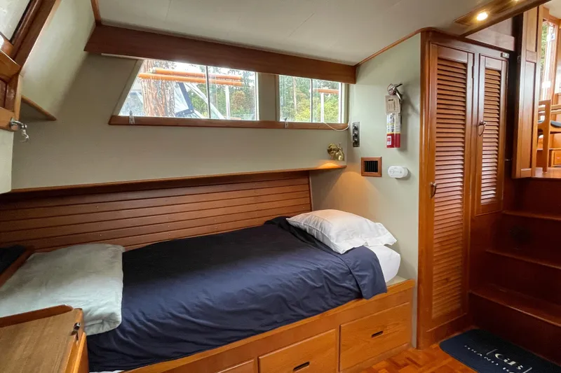 Mercator Yacht Photos Pics Cozy cabin interior of 1985 Grand Banks 42 Classic yacht with wooden furnishings and single bed.
