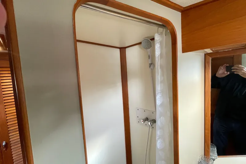 Mercator Yacht Photos Pics Shower area in 1985 Grand Banks 42 Classic yacht with wooden trim and mirror.
