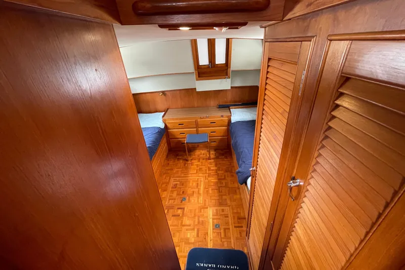 Mercator Yacht Photos Pics 1985 Grand Banks 42 Classic cabin interior with wooden finish and twin beds.