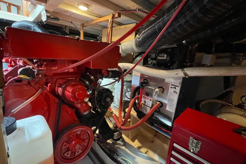 Mercator Yacht Photos Pics Engine room of a 1985 Grand Banks 42 Classic boat, featuring red machinery and equipment.