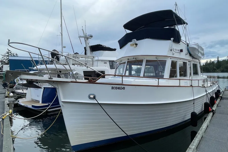 Mercator Yacht Photos Pics 1985 Grand Banks 42 Classic yacht docked at marina, showcasing elegant design and craftsmanship.