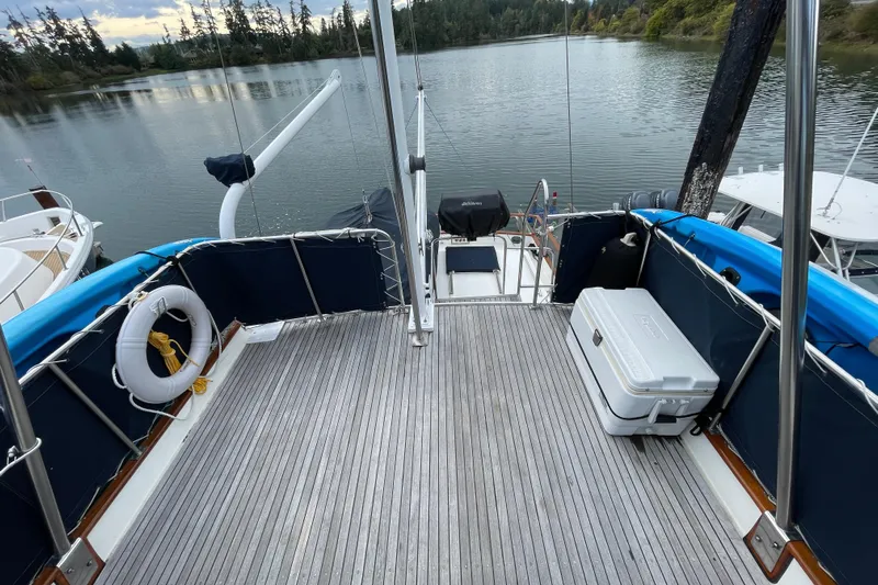 Mercator Yacht Photos Pics Grand Banks 42 Classic 1985 yacht deck with scenic lake view, featuring a cooler and life preserver.