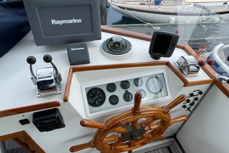 Mercator Yacht Photos Pics Helm of 1985 Grand Banks 42 Classic with Raymarine equipment and wooden steering wheel.