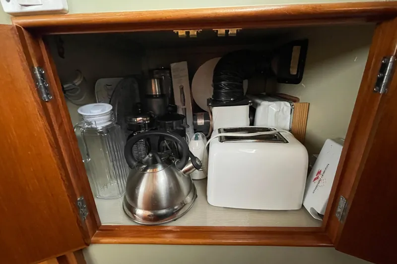 Mercator Yacht Photos Pics Kitchen cabinet on 1985 Grand Banks 42 Classic with kettle, toaster, and appliances.