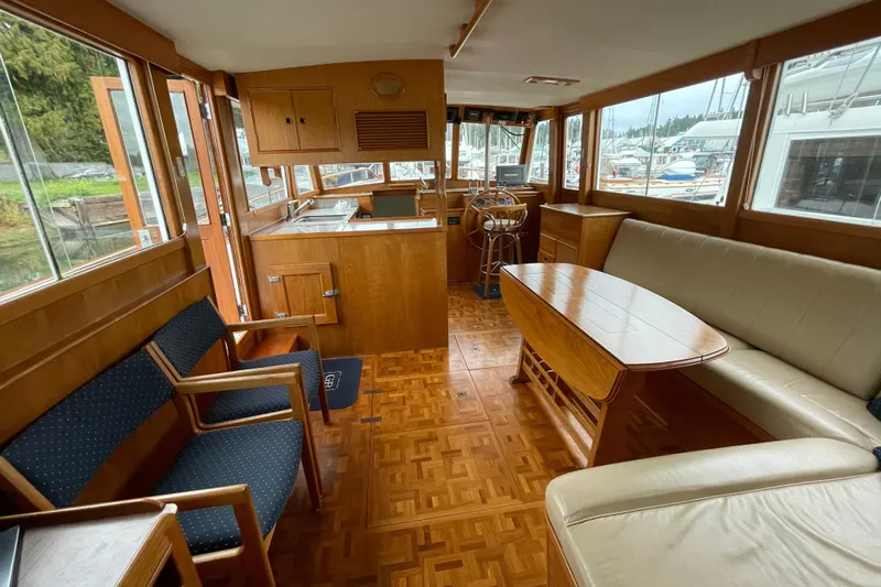 Mercator Yacht Photos Pics Interior of 1985 Grand Banks 42 Classic yacht with wood furnishings and seating area.