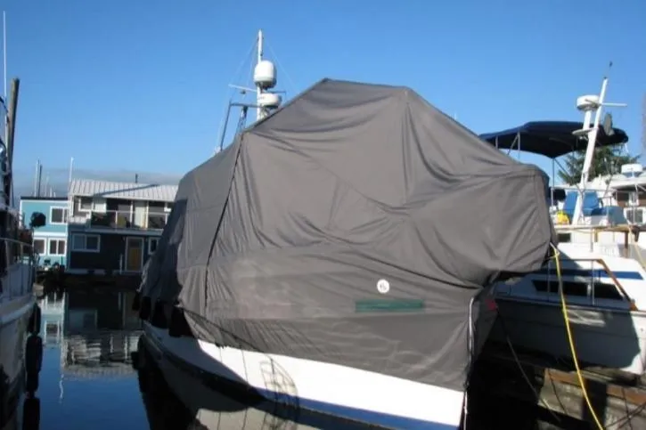 Mercator Yacht Photos Pics 1985 Grand Banks 42 Classic yacht covered with a protective tarp at a marina.