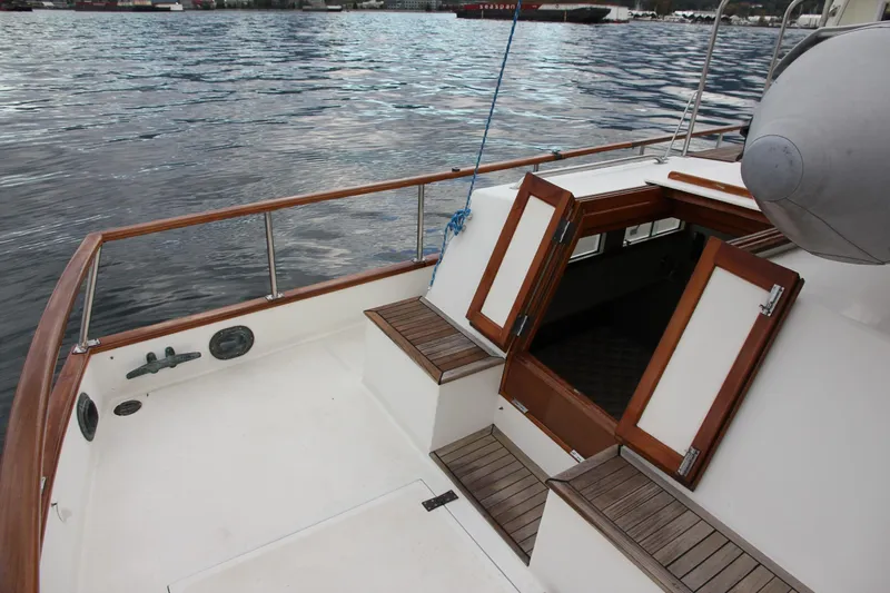 Mercator Yacht Photos Pics 1985 Grand Banks 42 Classic yacht deck with open hatch and wooden railings.