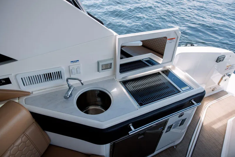 Lady Iryna Yacht Photos Pics 2022 Sea Ray Sundancer 320 Outboard boat kitchenette with sink and grill.