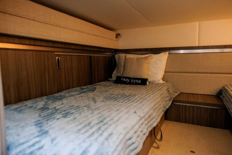 Lady Iryna Yacht Photos Pics 2022 Sea Ray Sundancer 320 Outboard cabin interior with cozy bedding and wood accents.