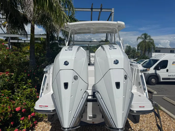  Yacht Photos Pics 2026 Blackfin 272 DC boat with dual outboard engines, parked outdoors.