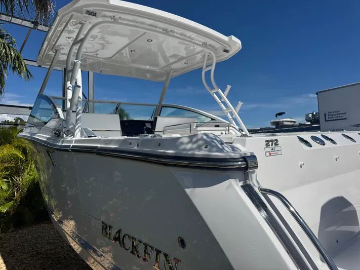  Yacht Photos Pics 2026 Blackfin 272 DC boat with sleek design under clear blue sky.