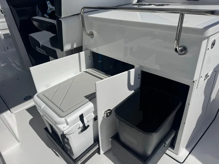  Yacht Photos Pics 2026 Blackfin 272 DC boat interior with storage compartments and cooler.