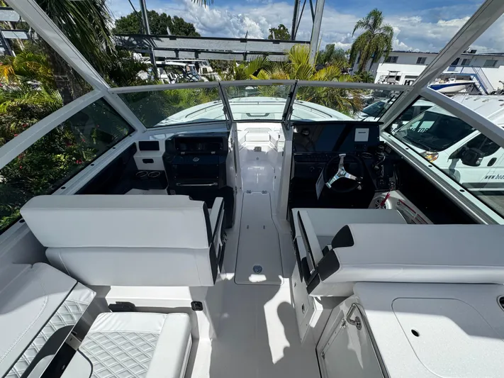  Yacht Photos Pics 2026 Blackfin 272 DC boat interior with white seating and modern dashboard.