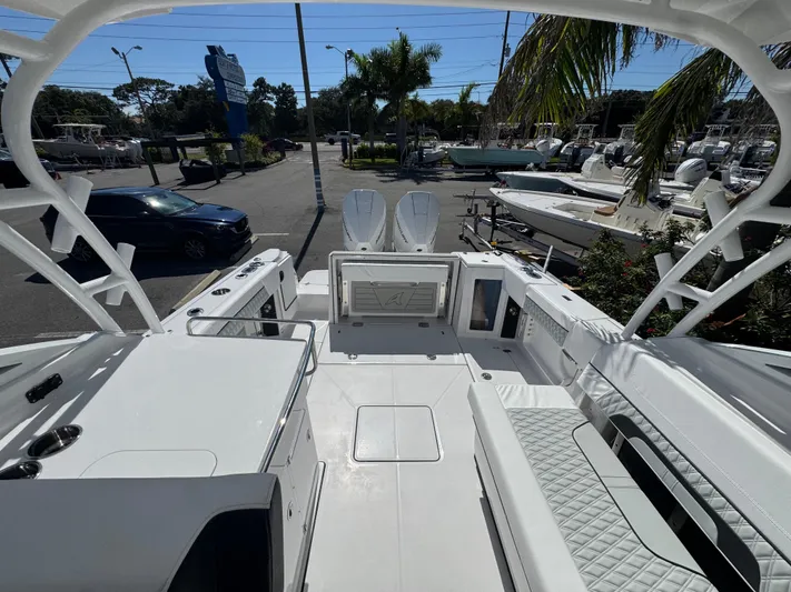  Yacht Photos Pics 2026 Blackfin 272 DC boat interior with seating and storage, parked at a marina.