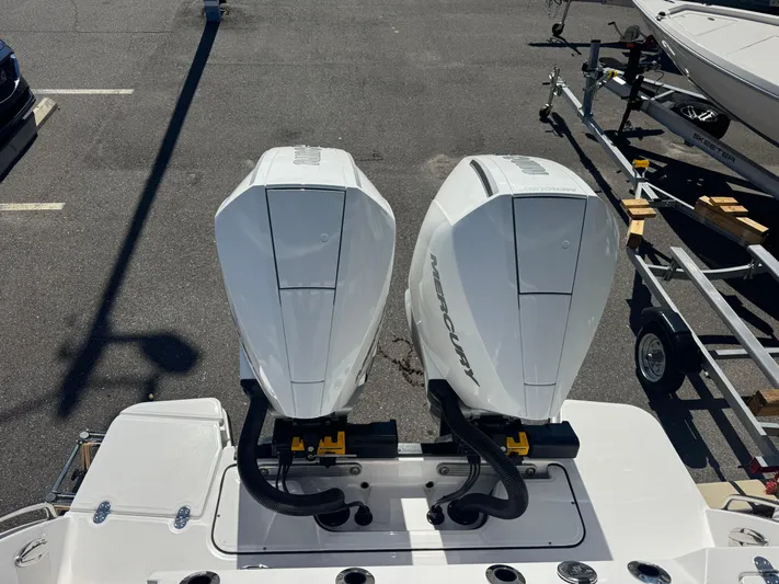  Yacht Photos Pics 2026 Blackfin 272 DC with dual Mercury outboard engines in a parking lot.